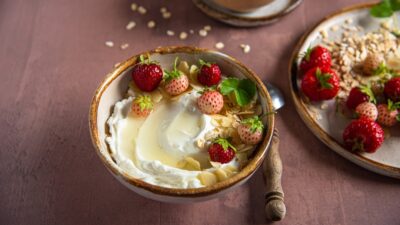 a bowl of yogurt with strawberries on top