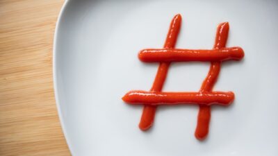 a white plate topped with hot dogs covered in ketchup