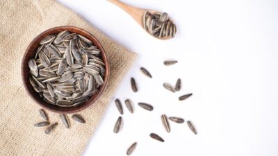 Sunflower seeds in a bowl and on a spoon.