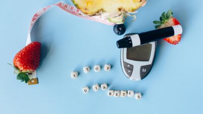 Conceptual flat lay with fruits, glucose meter, and message for diabetes prevention.