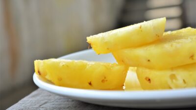 sliced yellow fruit on white ceramic plate