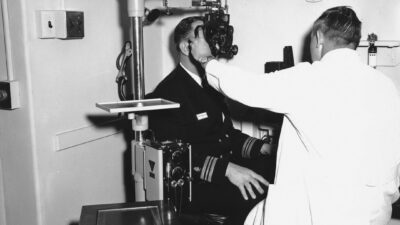 Doctor examining patient's eyes with equipment