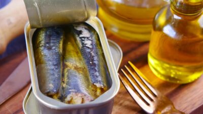 a tin of sardines sitting on top of a wooden table