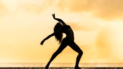 silhouette of woman making yoga pose