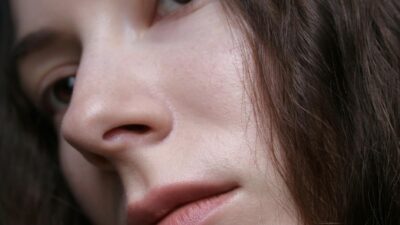 Detailed close-up portrait featuring the natural beauty of a woman's face and hair.