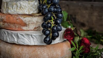 grape fruit hanging near red rose