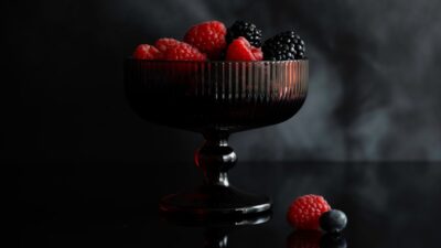 Dark glass bowl filled with fresh berries