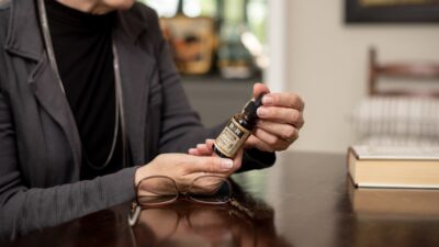person holding brown bottle