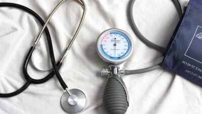 a stethoscope laying on top of a bed next to a medical bag