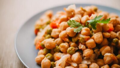 A close-up of a nutritious chickpea and vegetable salad on a plate, perfect for healthy eating.