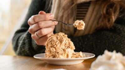 a woman eating a dessert with a spoon