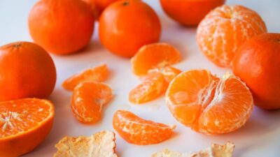sliced orange fruits on white ceramic plate
