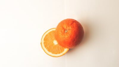 orange fruit on white surface