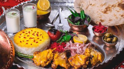 a silver plate topped with meat and vegetables