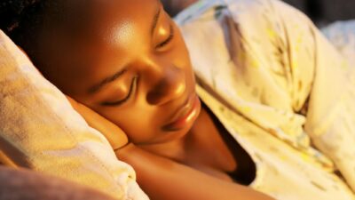 A serene close-up of a young woman sleeping peacefully indoors.