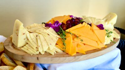 sliced cheese on brown wooden chopping board