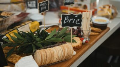 A delicious gourmet cheese platter featuring Brie cheese, crackers, and charcuterie.