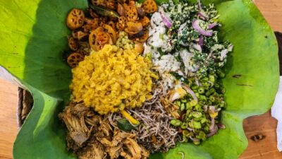 A sri lankan meal is presented on a leaf.