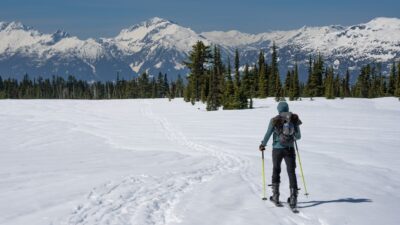 a man riding skis down a snow covered slope